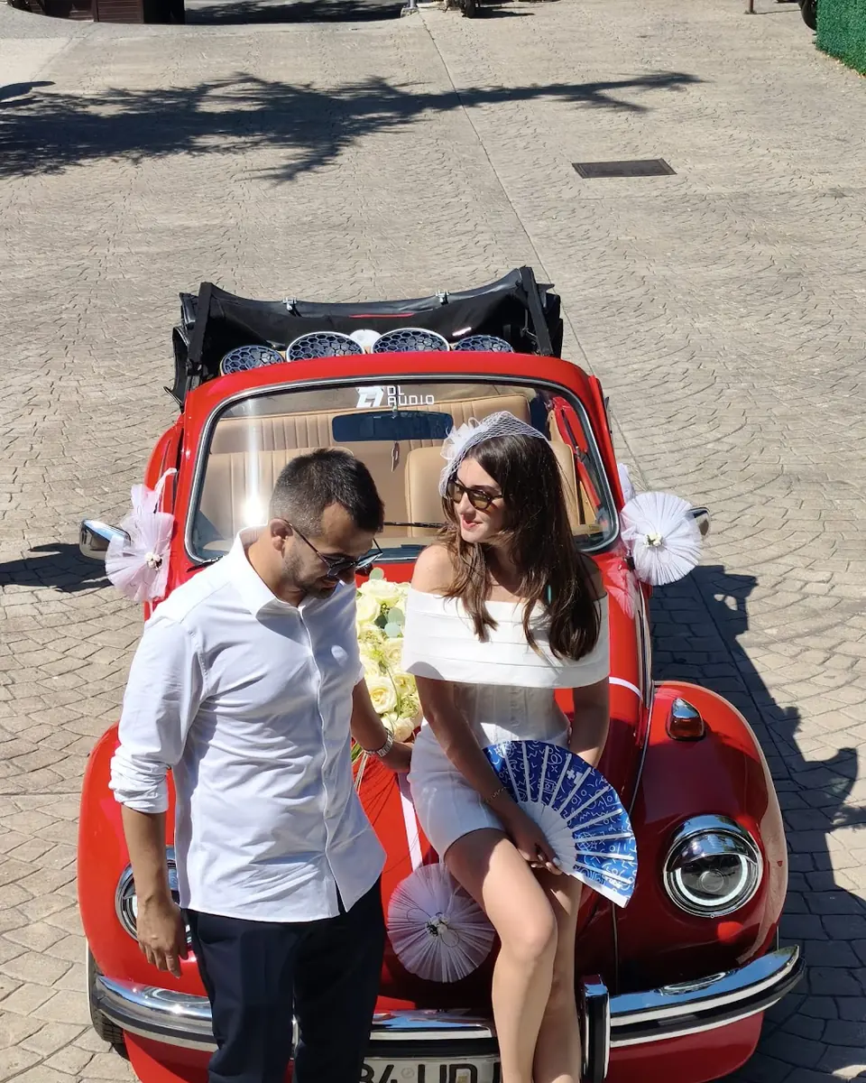Lucifer: arka tentesine DL Audio hoparlörler yerleştirilmiş kırmızı cabrio Vosvos gelin arabası, önünde gelin ve damat